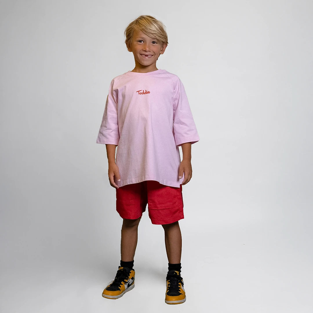 Child wearing pink oversized t-shirt with Toddie logo front, titled Sweet Harvest - Oversized Tee Pink.