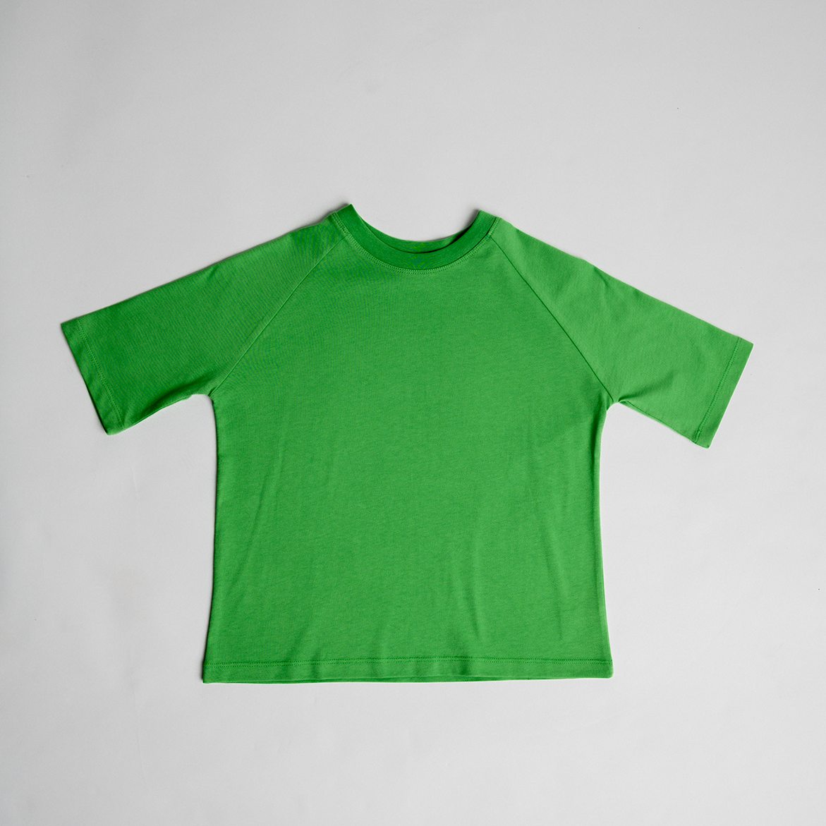 Oversized Tee in green, made from premium cotton, unisex design with a clean, simple look and comfy fit for active kids.