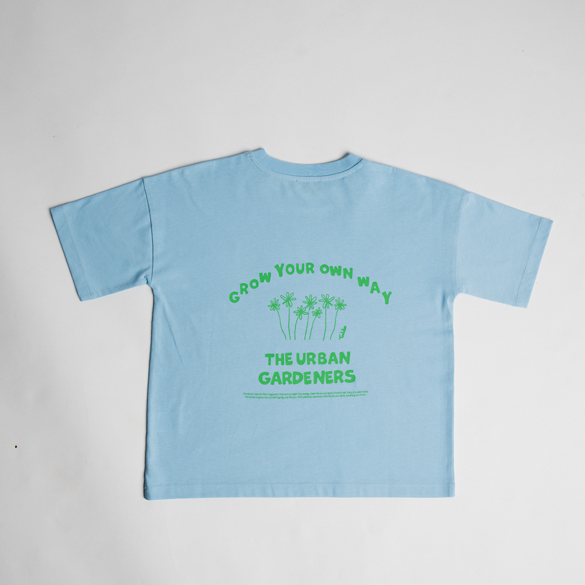 Light blue oversized tee with green "Grow Your Own Way" graphic and text, casual and comfy fit, Toddie GYOW - Oversized Tee