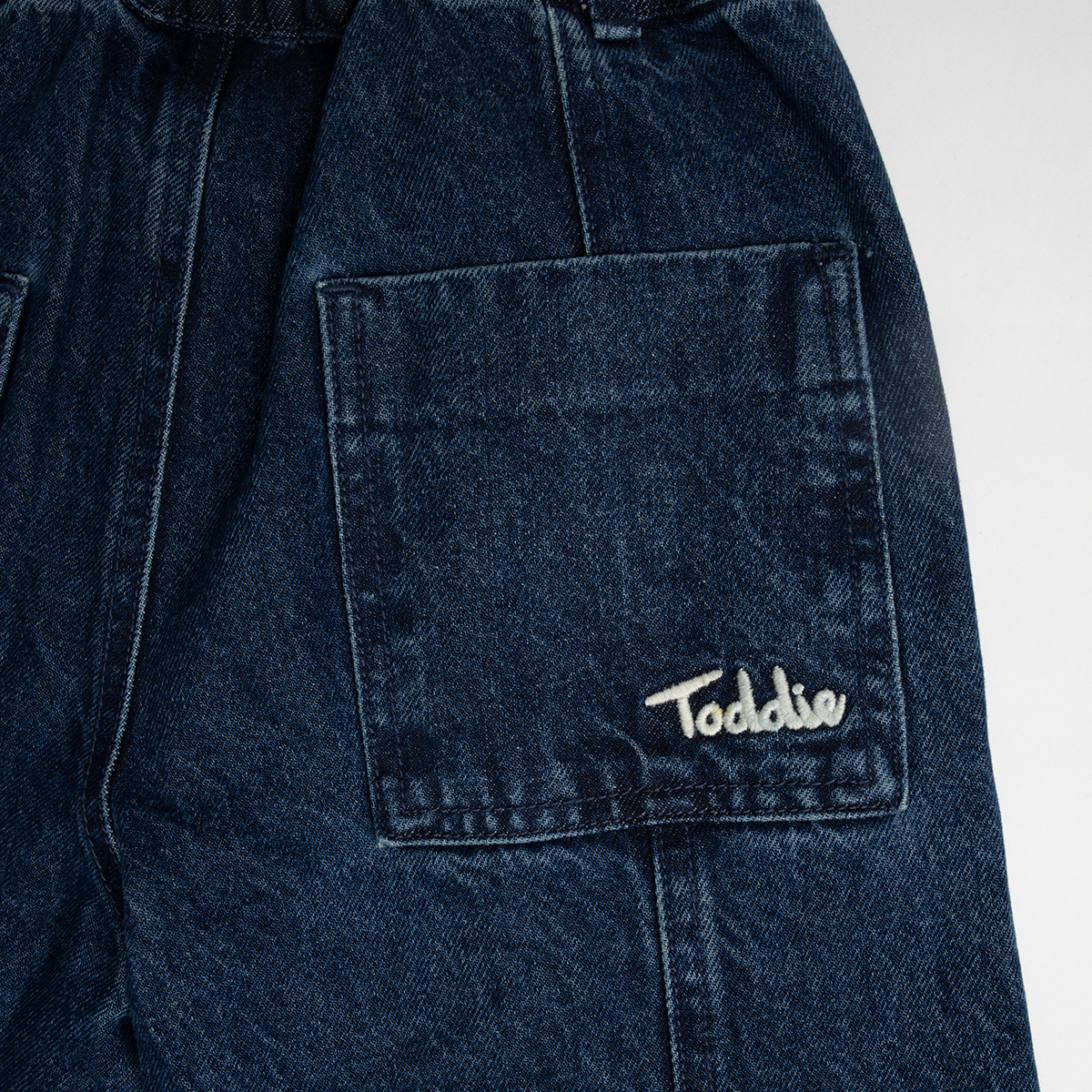 Close-up of the back pocket with Toddie logo on Balloon styled - Denim Jeans made from premium cotton.