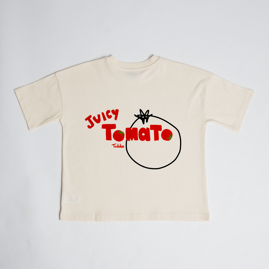 Juicy Tomato - Oversized Tee in cream with bold red tomato graphic and oversized baggy fit for kids.