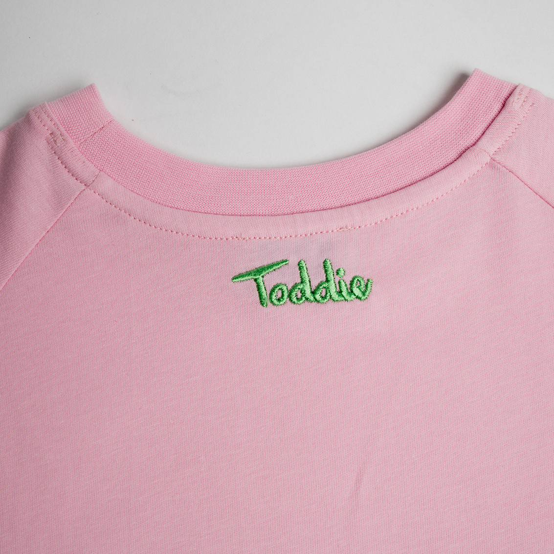 Pink Oversized Tee made of premium cotton with neat green Toddie embroidery on the back for a subtle touch.