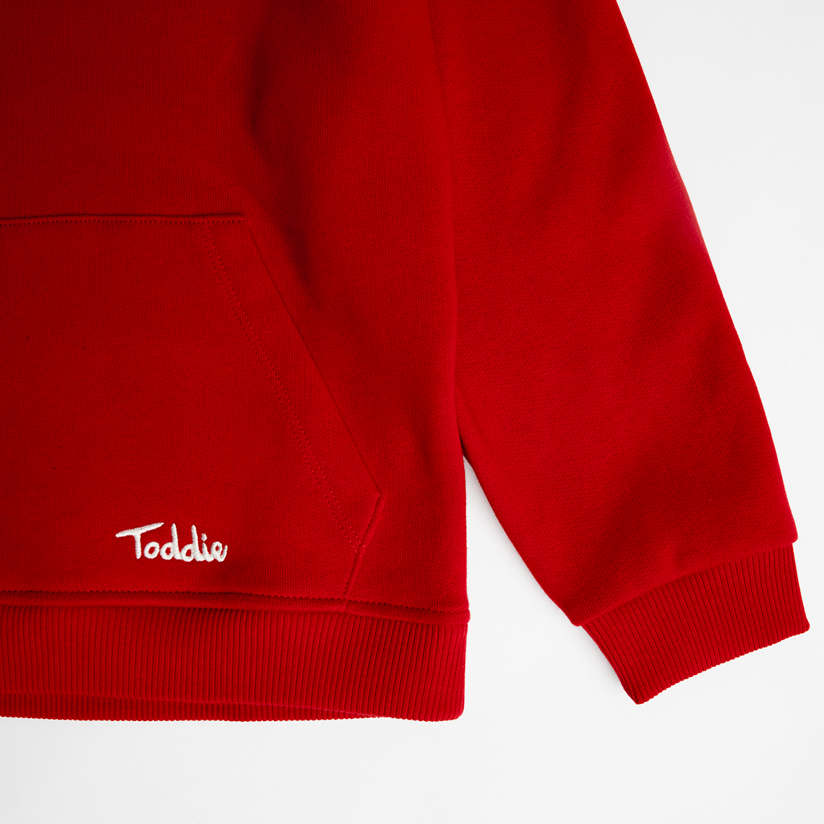 WMB - Oversized Hoodie Red showing soft cotton fabric, kangaroo pocket, and cuffed sleeve for cozy fit.