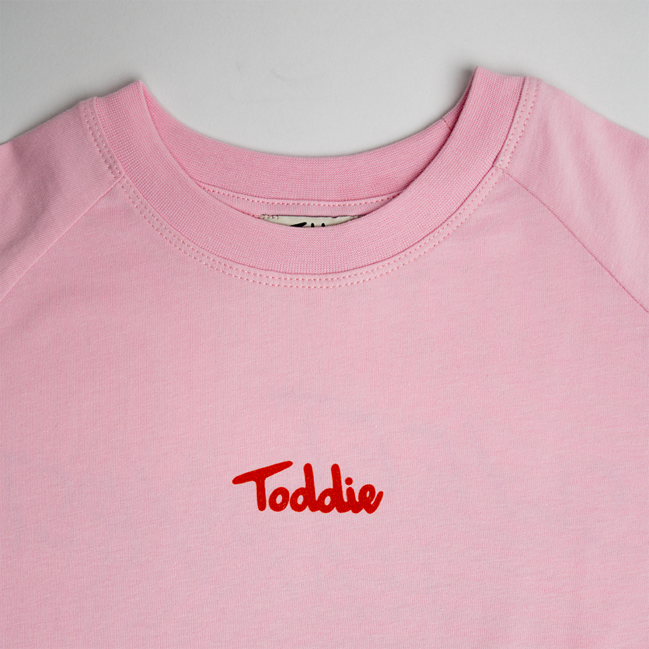 Sweet Harvest - Oversized Tee Pink with Toddie signature on front in red on soft pink cotton fabric.