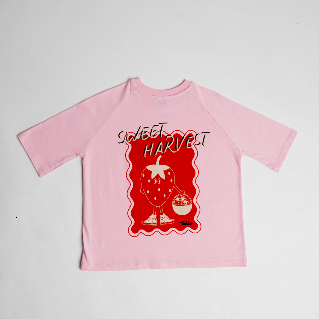 Sweet Harvest - Oversized Tee Pink featuring a playful sneaker-wearing strawberry graphic on soft pink cotton tee.