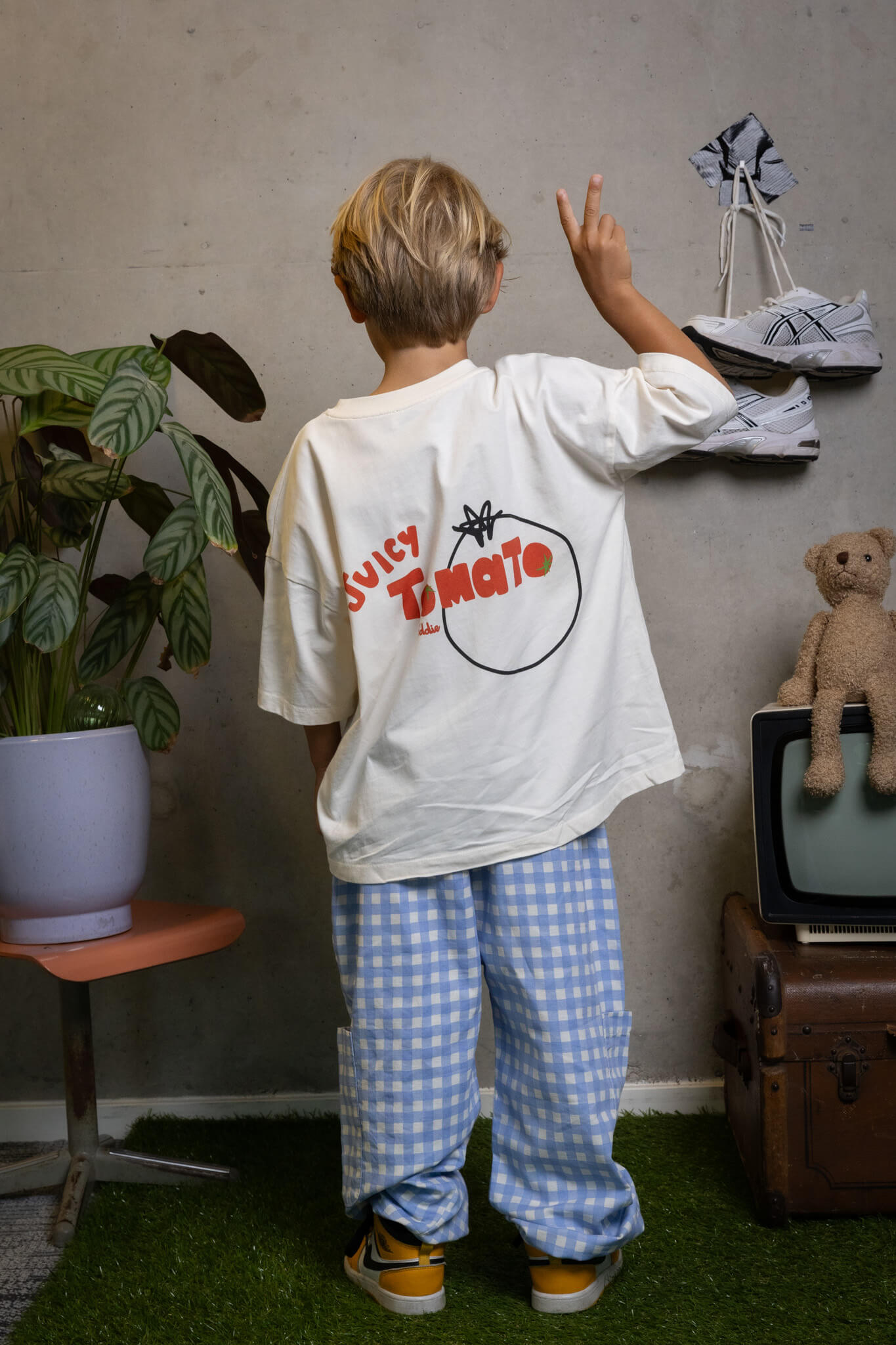 Kid rocking the playful FIT #6 tee with juicy tomato flair, confident style by Toddie.