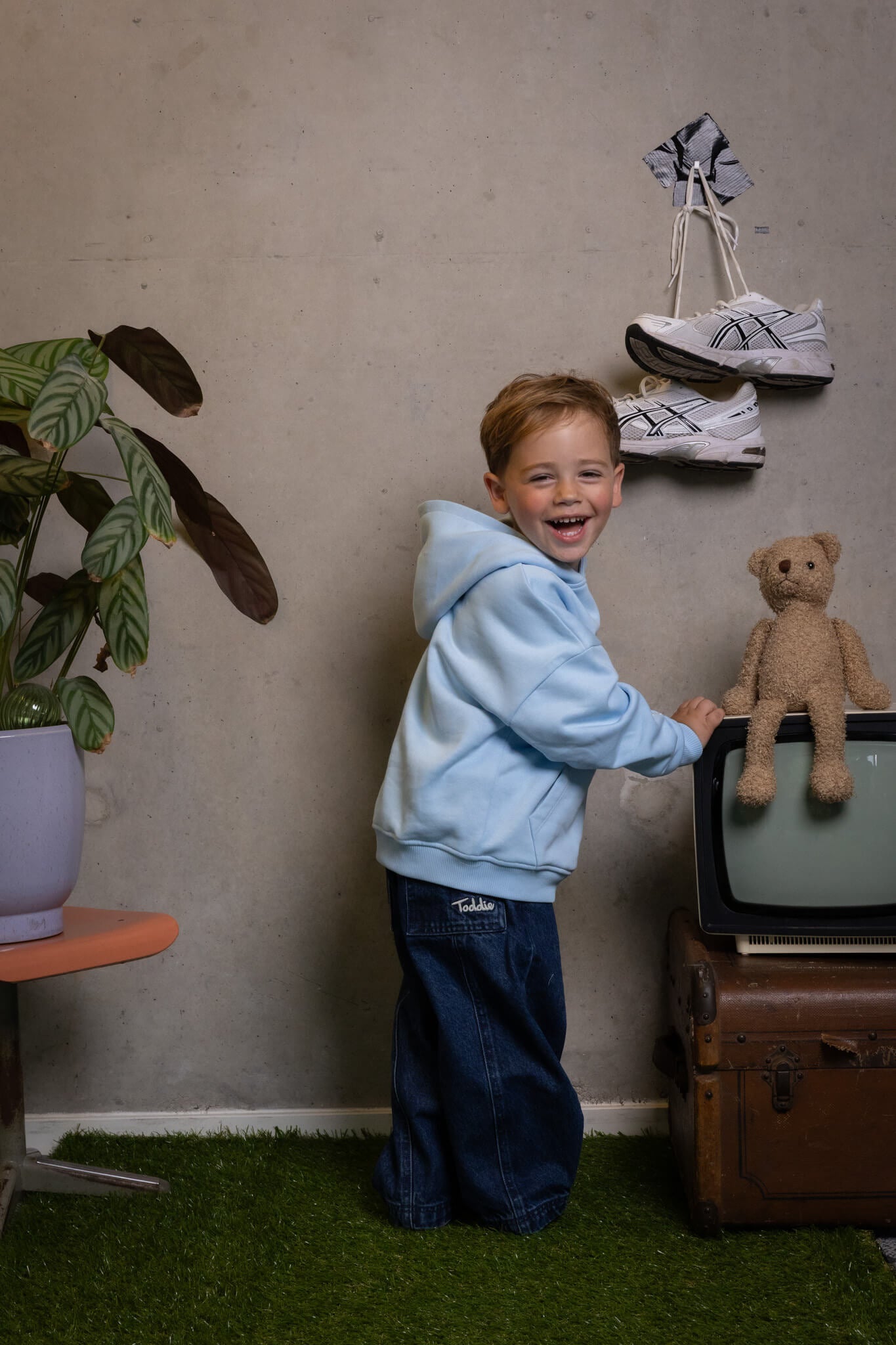 Happy kid rocking comfy FIT #1 hoodie and jeans that fit just right by Toddie, perfect for playful days.