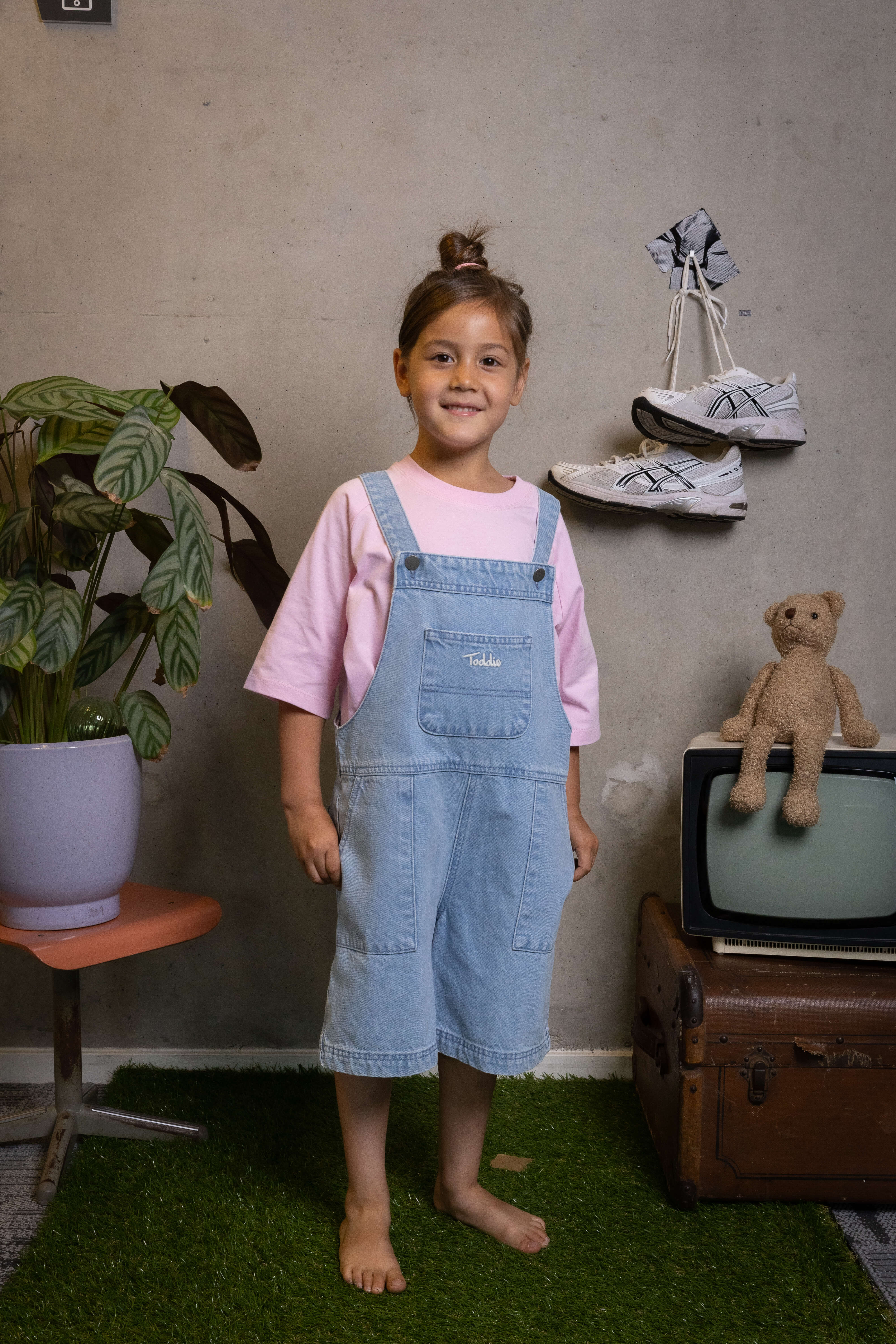Kid rocking relaxed denim dungarees with a soft pink tee, comfy, cute, and ready for play—FIT #13 by Toddie.