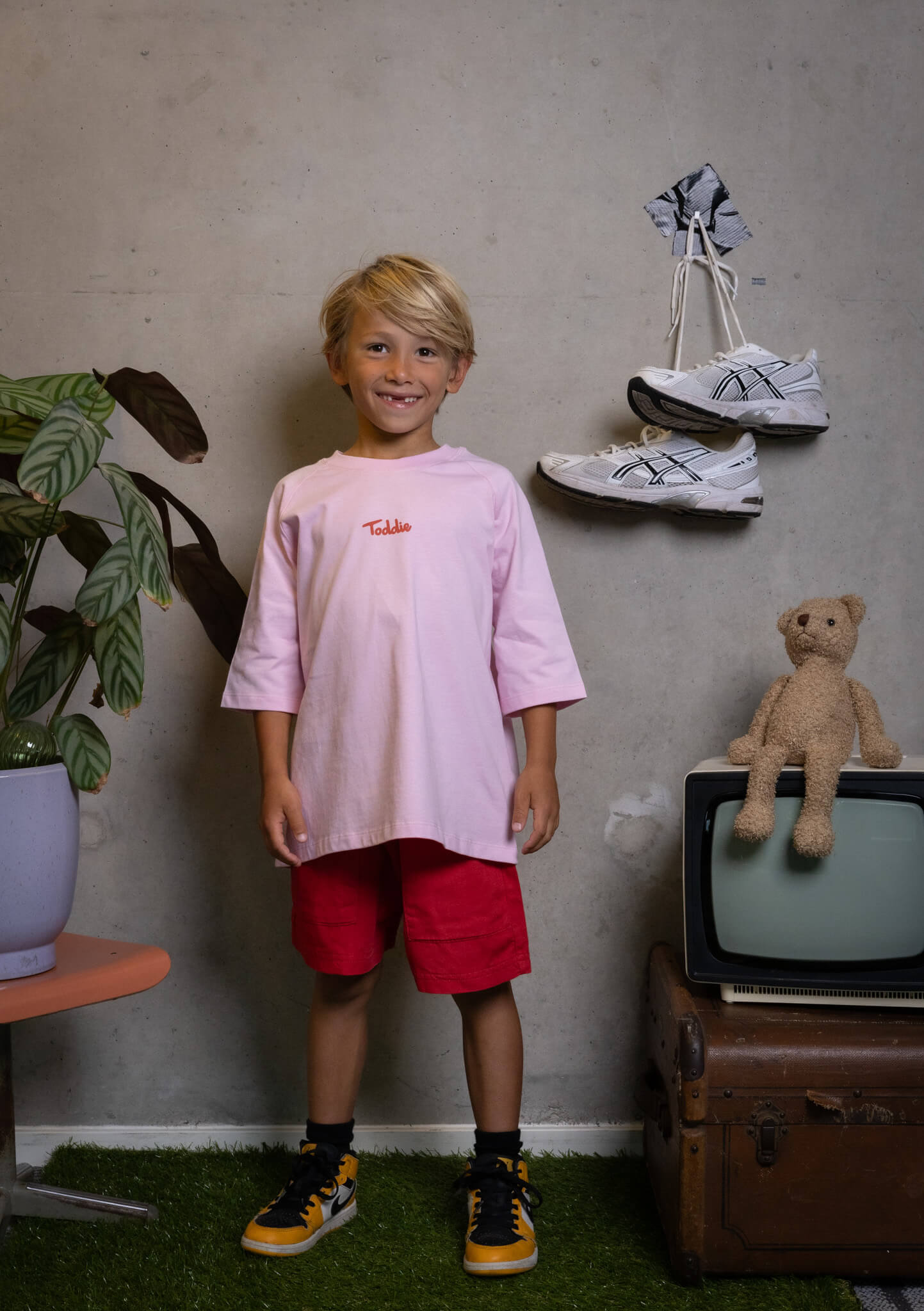Confident kid rocking FIT #4 with style and a smile, proving real fashion is fun and creative - Toddie.