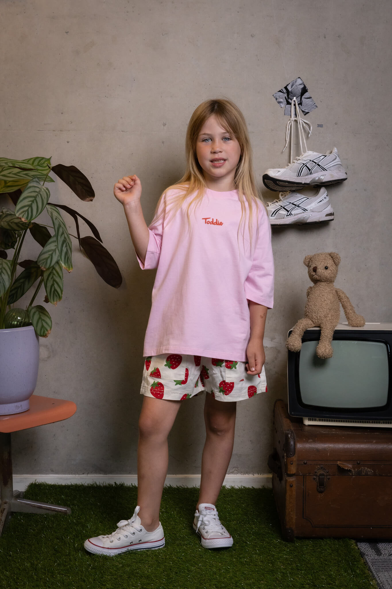 Confident kid rocking the FIT #10 pink tee and strawberry shorts, ready to rule the playground Toddie