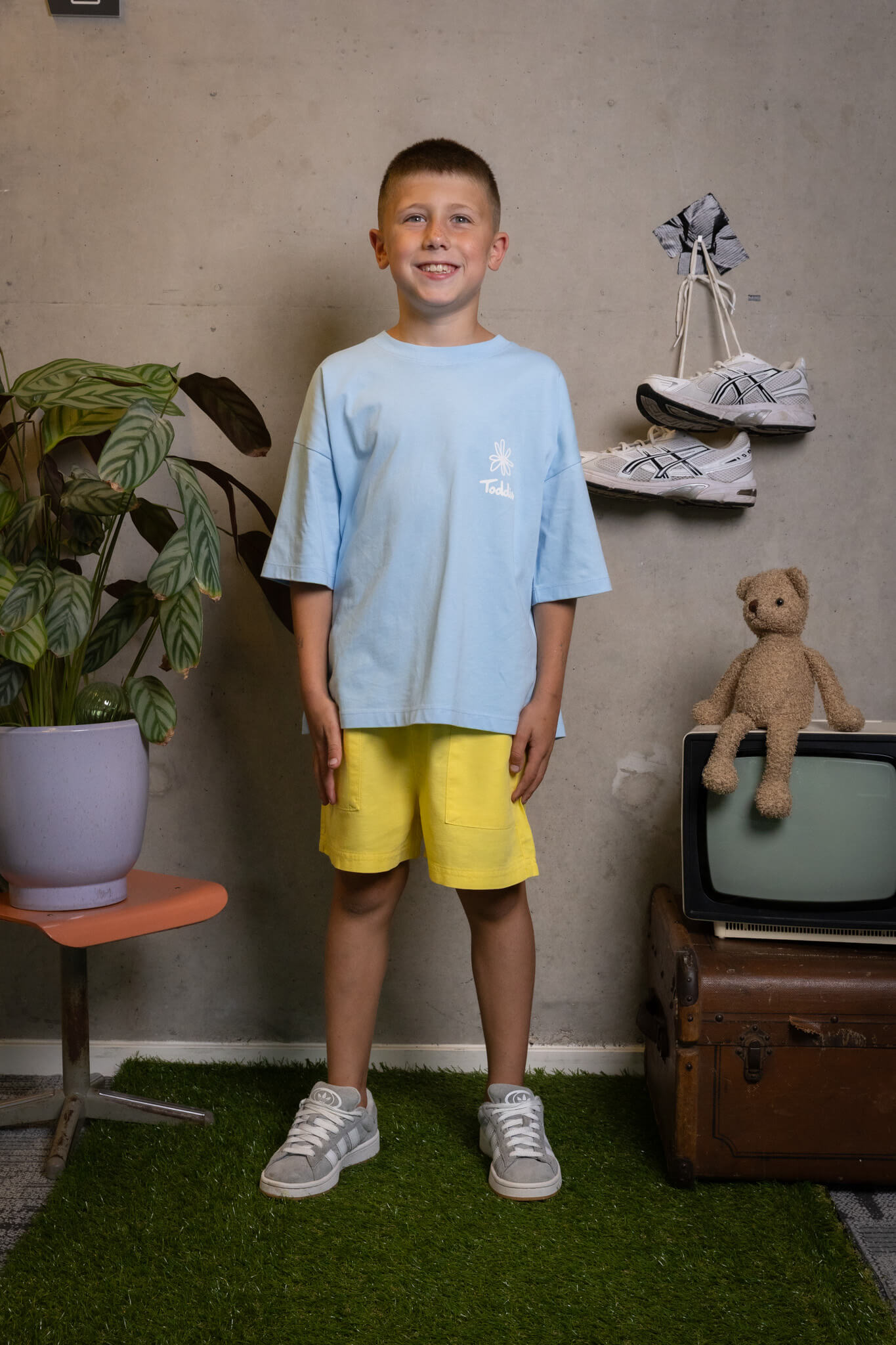 FIT #11 outfit: confident kid rocking bright shorts and a chill tee, ready to take on the day Toddie.