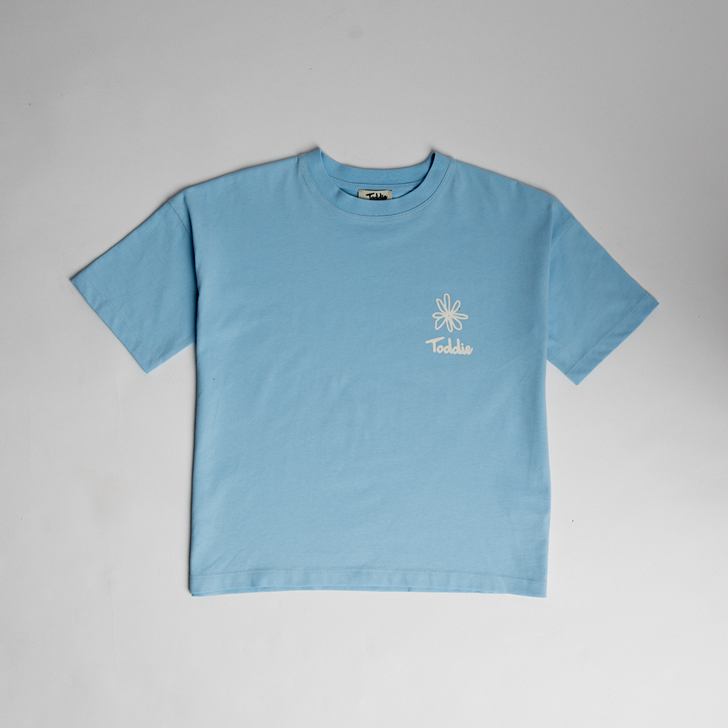 Light blue GYOW - Oversized Tee with simple white flower graphic, comfy relaxed fit for kids by Toddie.