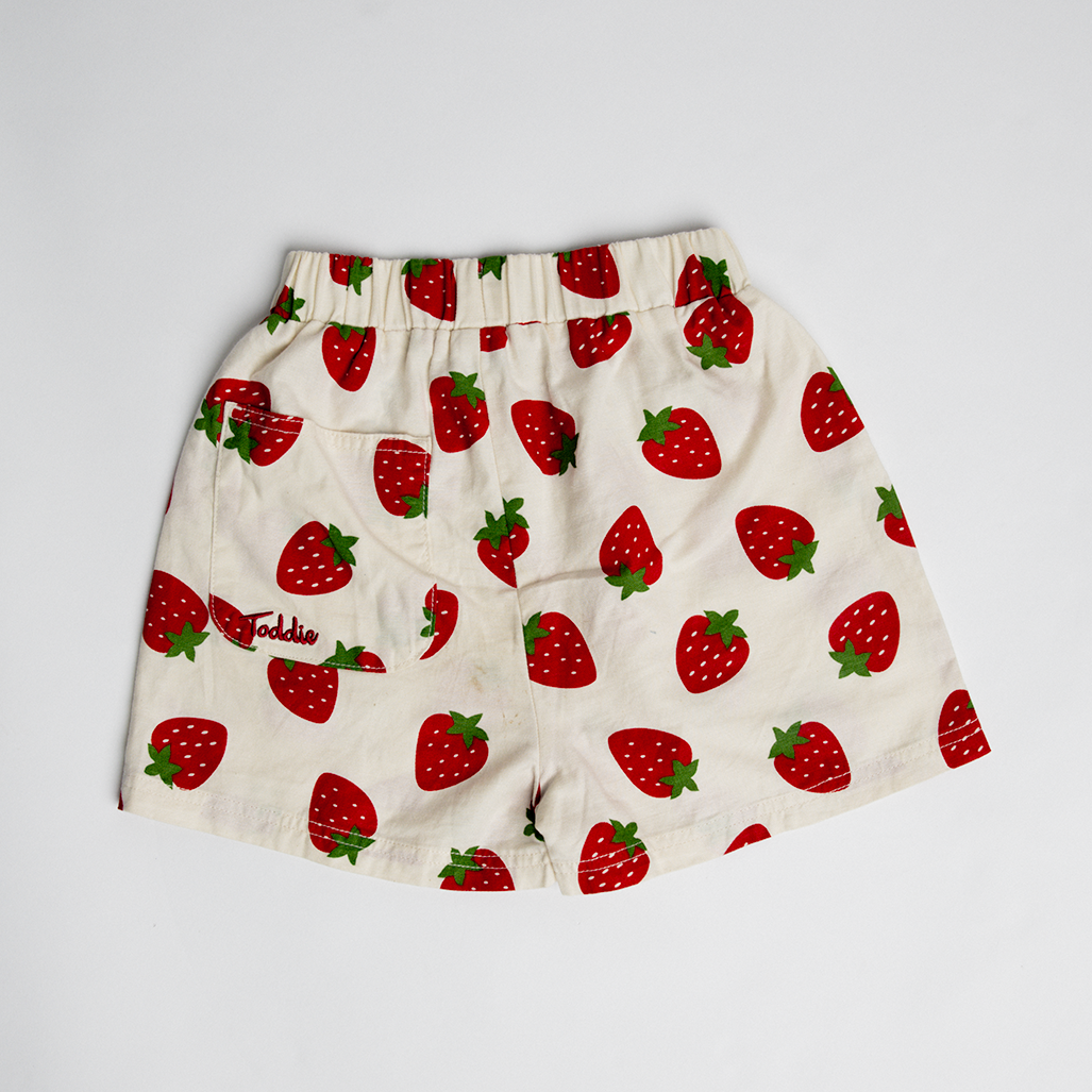 Strawberry Short shorts with all-over red strawberry print on creamy cotton fabric and a baggy comfortable fit.